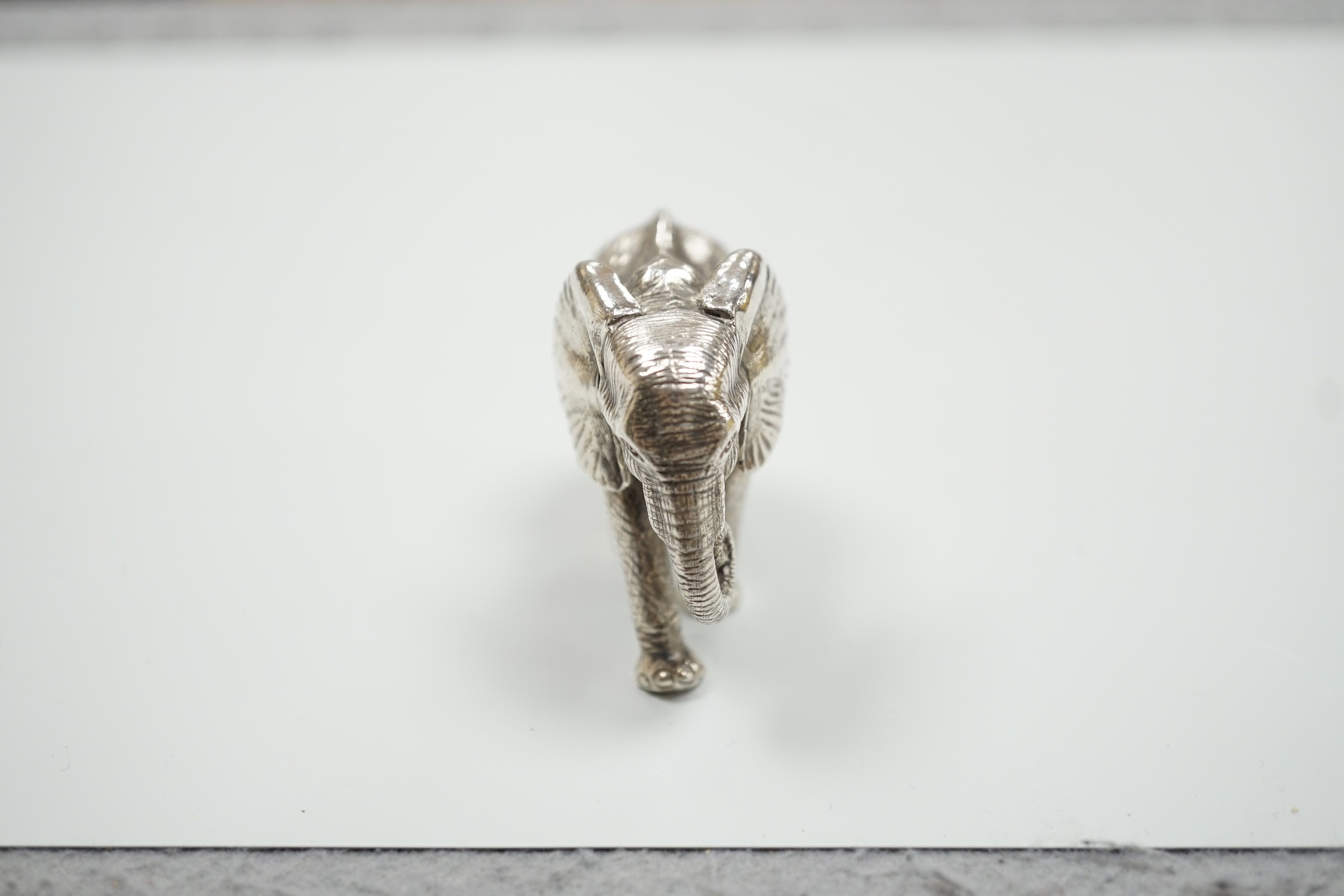 A modern Patrick Mavros miniature 925 model of an elephant, stamped 'Hasha', length 62mm, 219 grams.